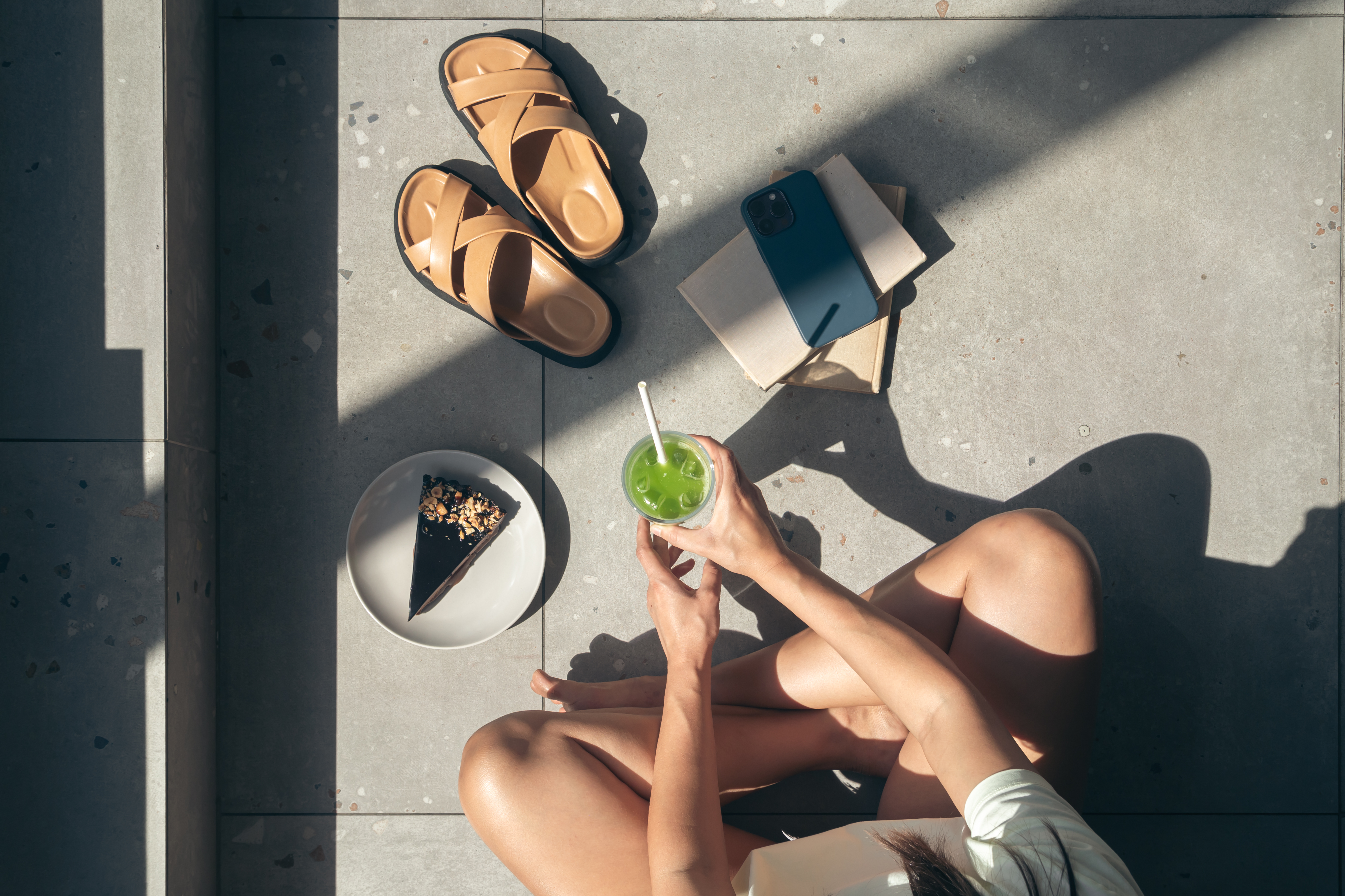 summer-composition-with-slippers-books-cake-lemonade-female-hands